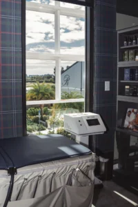 wellness treatment room with compression therapy setup and natural light view